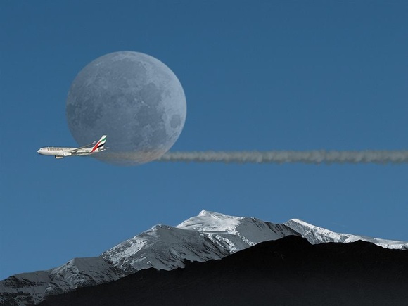 Full moon abeam for this Emirates fligh teasing north american mountains